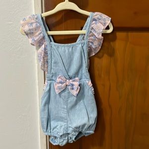 Jean romper with flower ruffle detail